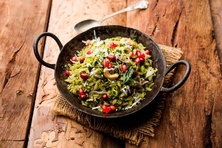 Hariyali Poha / Green Masala Pohe or flattened rice served in a bowl, selective focusの写真素材