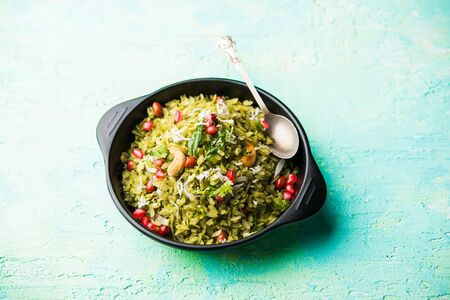 Hariyali Poha / Green Masala Pohe or flattened rice served in a bowl, selective focusの写真素材