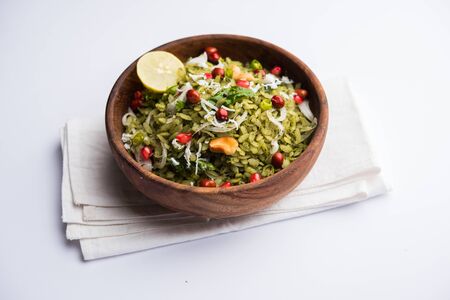 Hariyali Poha / Green Masala Pohe or flattened rice served in a bowl, selective focusの写真素材