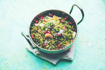Hariyali Poha / Green Masala Pohe or flattened rice served in a bowl, selective focusの写真素材