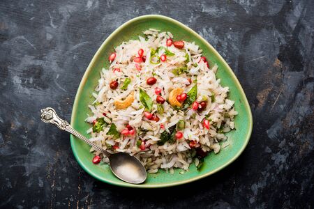 Dapde Pohe is a typical Maharashtrian breakfast, made with thin variety of poha and fresh coconut with chili, peanuts and nuts. served in a bowl or plate.の写真素材