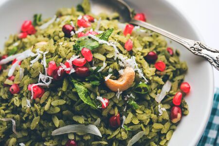 Hariyali Poha / Green Masala Pohe or flattened rice served in a bowl, selective focusの写真素材