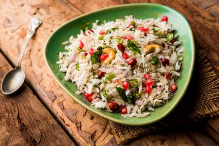 Dapde Pohe is a typical Maharashtrian breakfast, made with thin variety of poha and fresh coconut with chili, peanuts and nuts. served in a bowl or plate.の写真素材