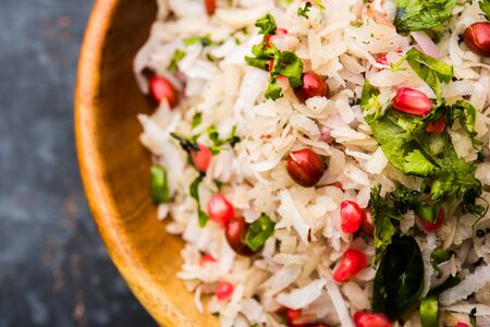 Dapde Pohe is a typical Maharashtrian breakfast, made with thin variety of poha and fresh coconut with chili, peanuts and nuts. served in a bowl or plate.の写真素材