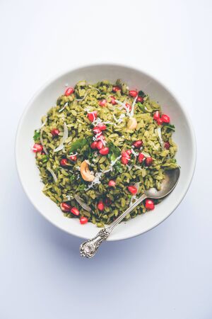Hariyali Poha / Green Masala Pohe or flattened rice served in a bowl, selective focusの写真素材