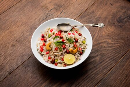 Dapde Pohe is a typical Maharashtrian breakfast, made with thin variety of poha and fresh coconut with chili, peanuts and nuts. served in a bowl or plate.の写真素材