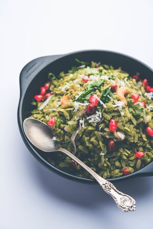 Hariyali Poha / Green Masala Pohe or flattened rice served in a bowl, selective focusの写真素材