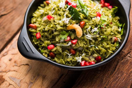 Hariyali Poha / Green Masala Pohe or flattened rice served in a bowl, selective focus