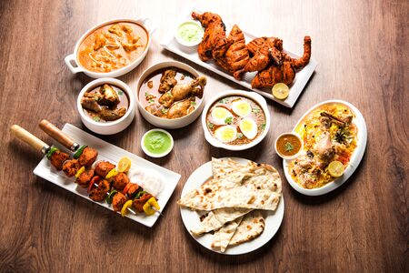 Assorted Indian Non Vegetarian food recipe served in a group. Includes Chicken Curry, Mutton Masala, Anda/egg curry, Butter chicken, biryani, tandoori murgh, chicken-tikka and naan/rotiの写真素材