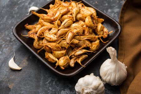 Garlic Fry or Tala Hua Lahsun in hindi, is a popular side dish or snacks from maharashtra, Indiaの写真素材