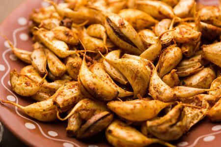Garlic Fry or Tala Hua Lahsun in hindi, is a popular side dish or snacks from maharashtra, Indiaの写真素材