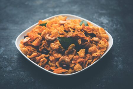 Cornflake Chivda or Corn Chiwda loaded with peanuts and Cashew. Served in a bowl. selective focusの写真素材