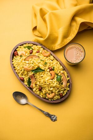 Jada Poha Namkeen Chivda / Thick Pohe Chiwda is a jar snack with a mix of sweet, salty and nuts flavours, served with tea. selective focusの写真素材