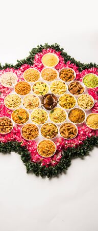 Rangoli of Farsan/snacks in bowls for Diwali with diyaの写真素材
