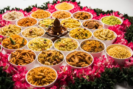 Rangoli of Farsan/snacks in bowls for Diwali with diyaの写真素材