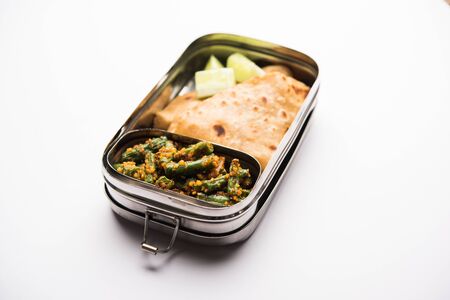Lunch Box / Tiffin for Indian kids, includes beans vegetable sabzi with roti or chapatiの写真素材
