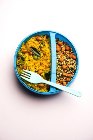 Lunch Box / Tiffin for Indian kids, hot Poha made using beaten rice and spices, accompanied with sproutsの写真素材