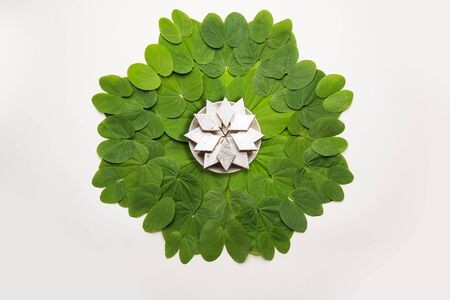Indian Festival Dussehra, symbolic Golden or Piliostigma leaf or Bauhinia racemosa also known as Apta patti, arranged in circular pattern with Kaju Katli sweet burfi in plate at centreの写真素材