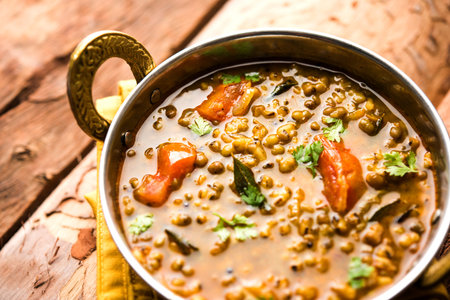 Whole Green Moong Dal fry / Whole Mung bean Tadka served in a bowl. selective focus