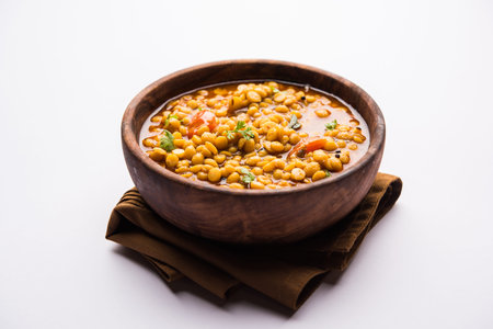 cooked Chana Dal fry or Split Bengal Gram tadka served in a bowl or pan, selective focus