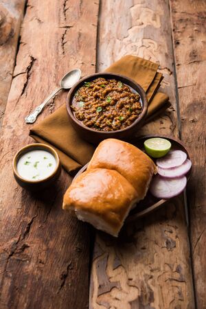 Kheema / keema Pav or Khima Paav is a spicy curry dish made up of minced chicken or lamb cooked with onion, tomatoes, served with buns.の写真素材