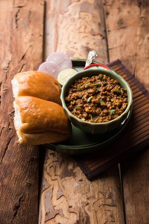 Kheema / keema Pav or Khima Paav is a spicy curry dish made up of minced chicken or lamb cooked with onion, tomatoes, served with buns.の写真素材