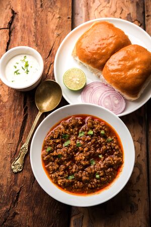 Kheema / keema Pav or Khima Paav is a spicy curry dish made up of minced chicken or lamb cooked with onion, tomatoes, served with buns.の写真素材