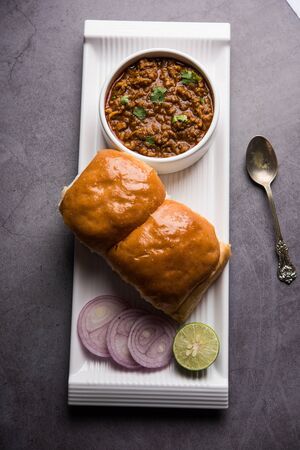 Kheema / keema Pav or Khima Paav is a spicy curry dish made up of minced chicken or lamb cooked with onion, tomatoes, served with buns.の写真素材