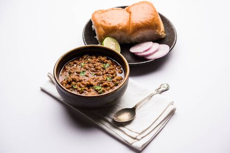 Kheema / keema Pav or Khima Paav is a spicy curry dish made up of minced chicken or lamb cooked with onion, tomatoes, served with buns.の写真素材