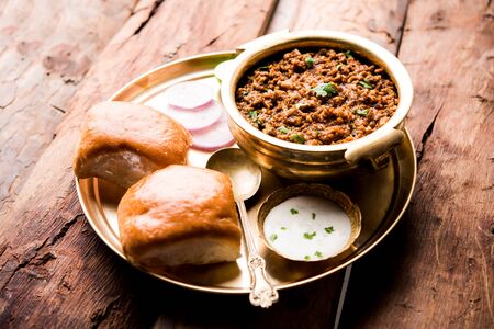 Kheema / keema Pav or Khima Paav is a spicy curry dish made up of minced chicken or lamb cooked with onion, tomatoes, served with buns.の写真素材