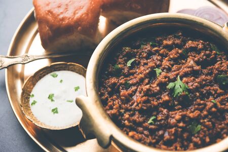 Kheema / keema Pav or Khima Paav is a spicy curry dish made up of minced chicken or lamb cooked with onion, tomatoes, served with buns.の写真素材