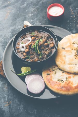 Pindi Chole Kulche or roadside choley Kulcha is a popular streetfood in India and pakistan. It's a spicy Chickpea or chana curry served with Indian Flat Bread.の写真素材
