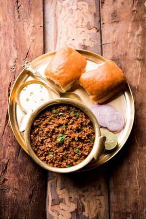 Kheema / keema Pav or Khima Paav is a spicy curry dish made up of minced chicken or lamb cooked with onion, tomatoes, served with buns.の写真素材