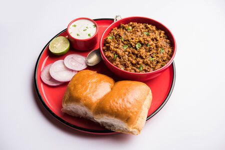 Kheema / keema Pav or Khima Paav is a spicy curry dish made up of minced chicken or lamb cooked with onion, tomatoes, served with buns.の写真素材