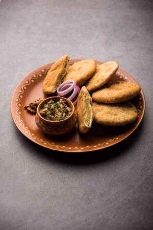 Fried Sattu Litti chokha served with Baingan Bharta, onion and pickle, popular recipe from Bihar, Indiaの写真素材