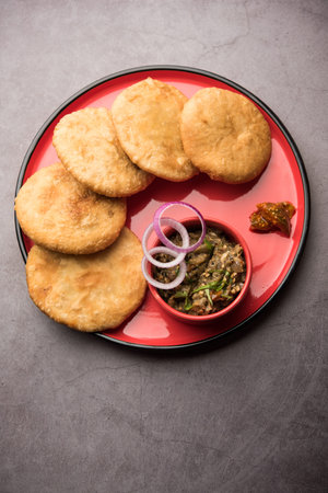 Fried Sattu Litti chokha served with Baingan Bharta, onion and pickle, popular recipe from Bihar,...