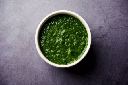 Kothimbir or Dhaniya Chutney made using cilantro or coriander with chilli, served in a bowl.の写真素材