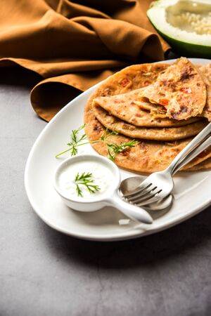 Raw Papaya Paratha or Papita ke Parathe made using Made using papaya, wheat flour, cumin seeds, ginger. Popular Indian food recipe served hot with curd. selective focusの写真素材