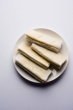 Pootharekulu is a popular recipe originated from Andhra Pradesh, India. It is a paper-thin sweet or dessert made from rice start/gram flour, jaggery/sugar and clarified butter.の写真素材