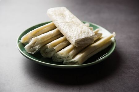 Pootharekulu is a popular recipe originated from Andhra Pradesh, India. It is a paper-thin sweet or dessert made from rice start/gram flour, jaggery/sugar and clarified butter.の写真素材