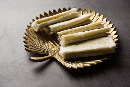 Pootharekulu is a popular recipe originated from Andhra Pradesh, India. It is a paper-thin sweet or dessert made from rice start/gram flour, jaggery/sugar and clarified butter.の写真素材