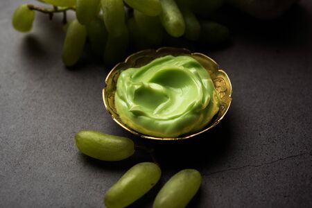 Green grapes, yogurt and honey mix face mask or cream for skin dark spot removal treatment, created using Angoor extract, curd and honey. selective focusの写真素材