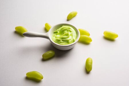 Green grapes, yogurt and honey mix face mask or cream for skin dark spot removal treatment, created using Angoor extract, curd and honey. selective focusの写真素材