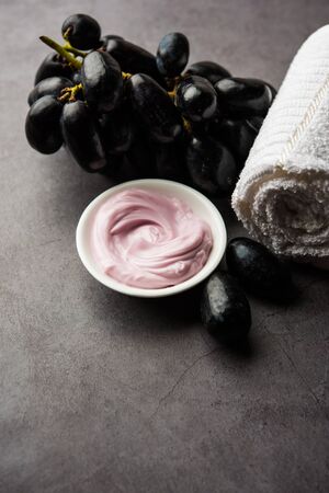 Black grapes, yogurt and honey mix face mask or cream for skin dark spot removal treatment, created using Angoor extract, curd and honey. selective focusの写真素材