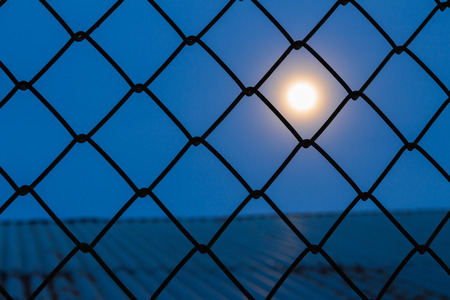 Moon looked out of the shadows in prison.の写真素材
