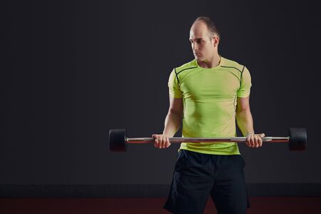 Man at the gym lifting weightsの写真素材