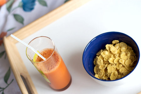 Easy breakfast from corn-flakes and carrots juice