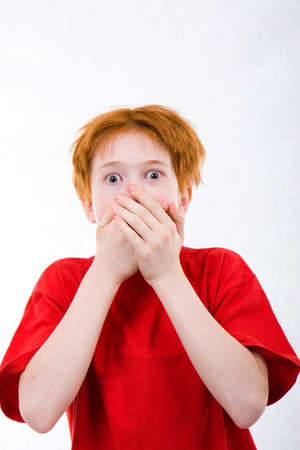Red teen was frightened. The white background isolatedの写真素材