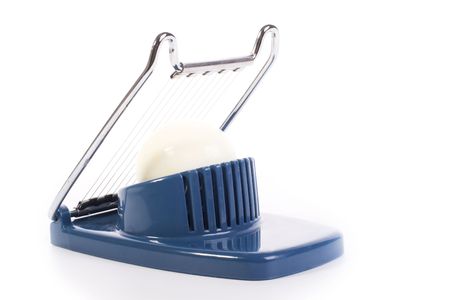 egg cutter with an egg isolated on white backgroundの写真素材