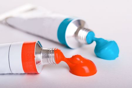 Red and blue paint from a tuba on a paper backgroundの写真素材